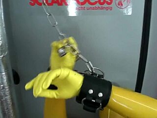 Sensual blonde babe in yellow latex catsuit and fishnets gets kinky with bondage
